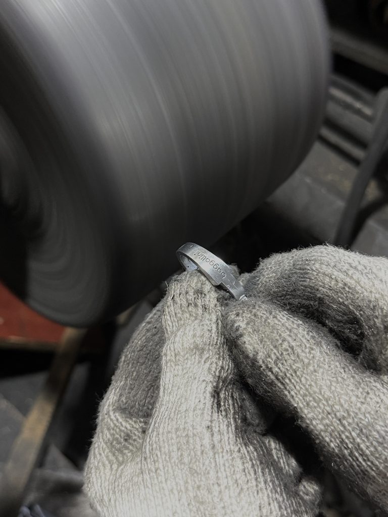 polishing a snap hook with hands