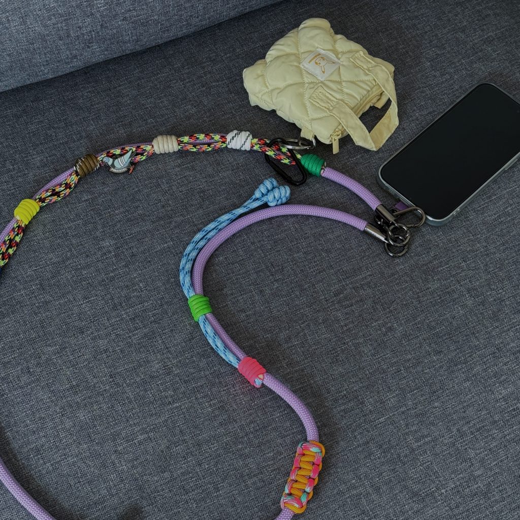 Purple phone strap with a tiny bag charm