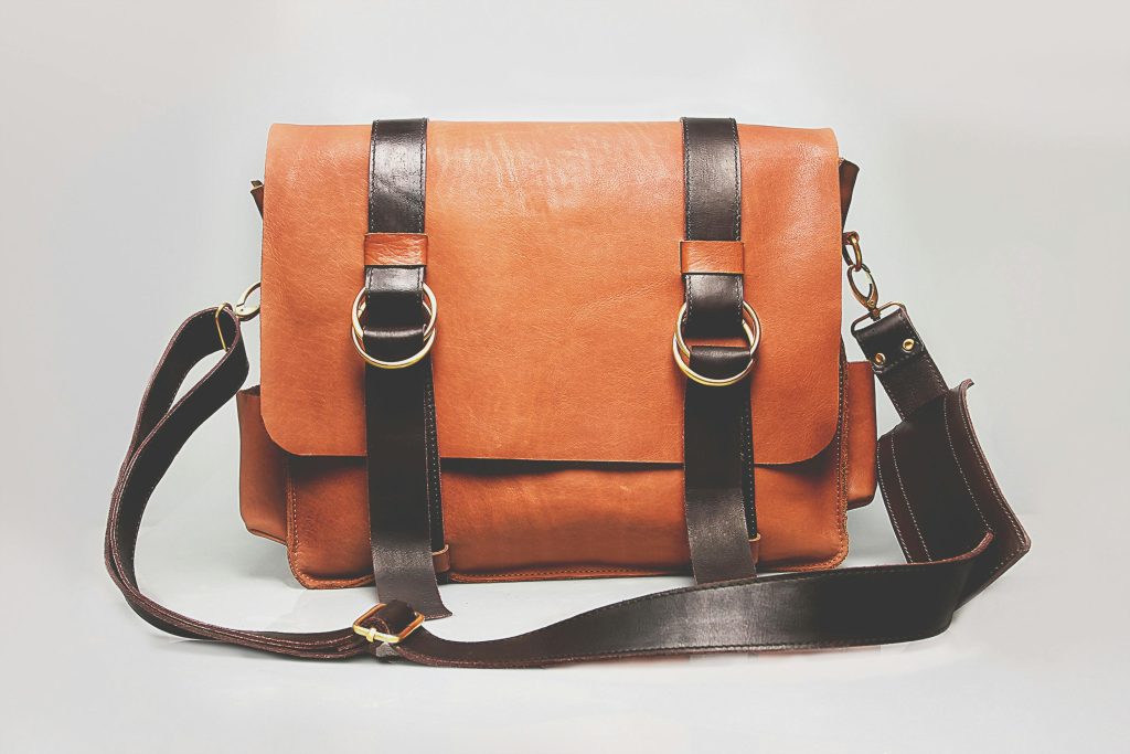 Leather messenger bag with metal hardware