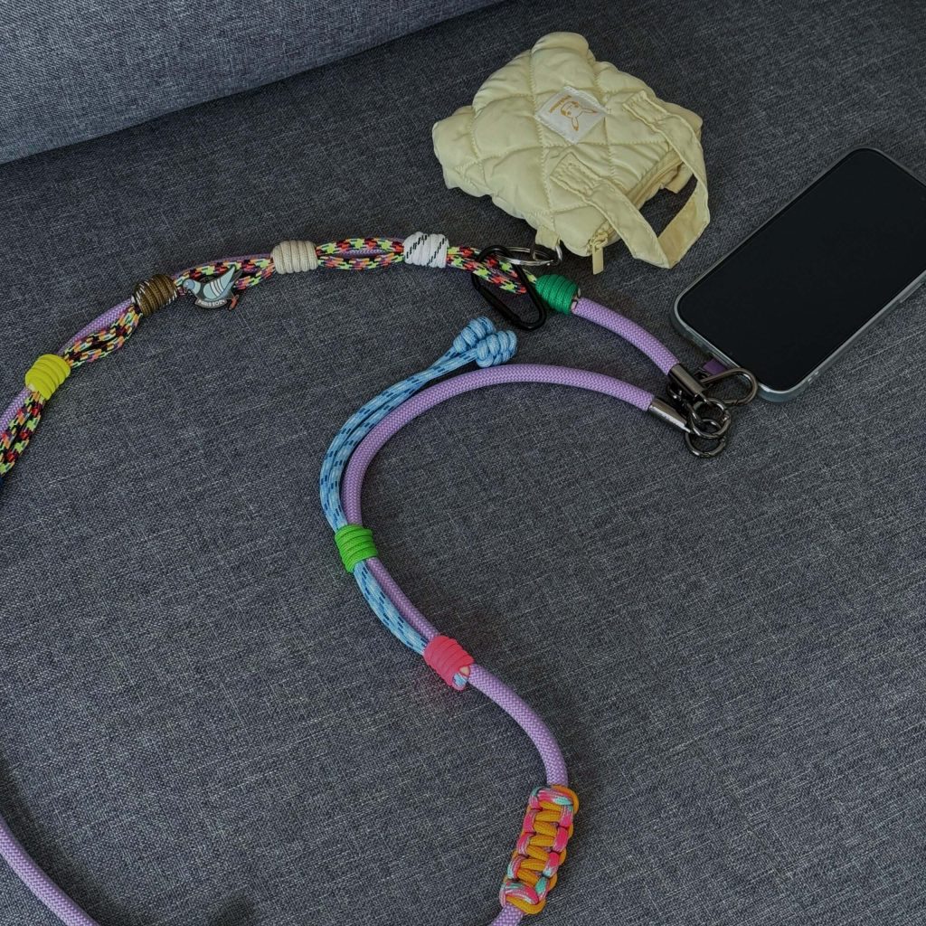 Purple phone strap with a tiny bag charm