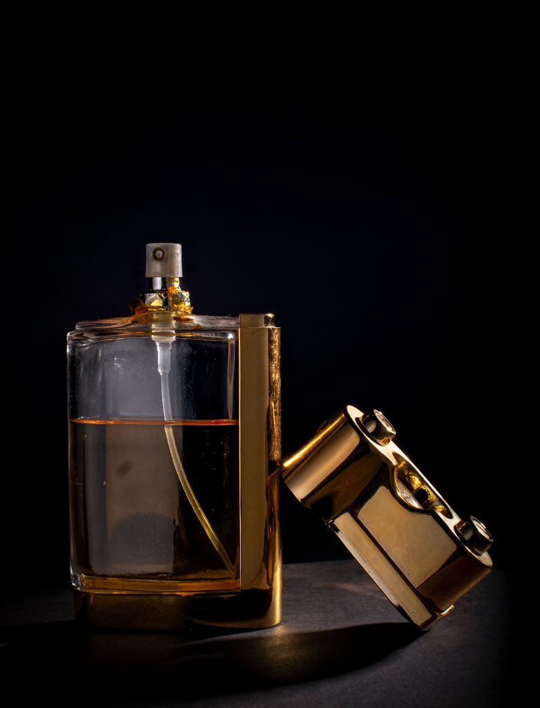 perfume with a golden cap